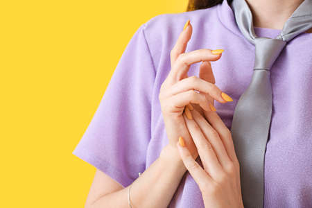 Young woman with beautiful manicure on color background
