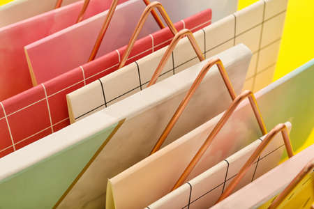 Stand with notebooks on color background, closeupの写真素材