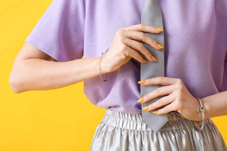 Young woman with beautiful manicure on color backgroundの写真素材