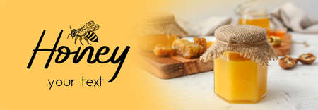 Jar of sweet honey on table with space for textの写真素材