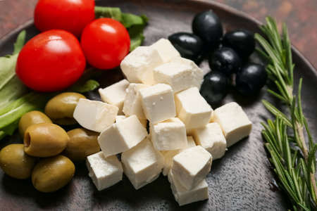 Composition with delicious pieces of feta cheese on plateの写真素材