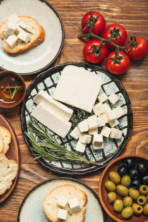 Composition with delicious pieces of feta cheese on wooden background
