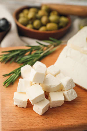 Delicious pieces of feta cheese on boardの写真素材