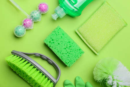 Set of cleaning supplies on color background