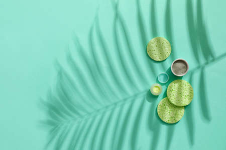 Composition with makeup sponges and cosmetic products on color backgroundの写真素材