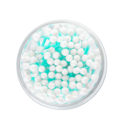 Glass with cotton swabs on white background