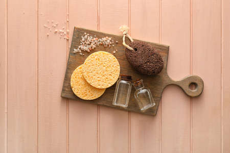 Composition with makeup sponges and bath supplies on color wooden backgroundの写真素材