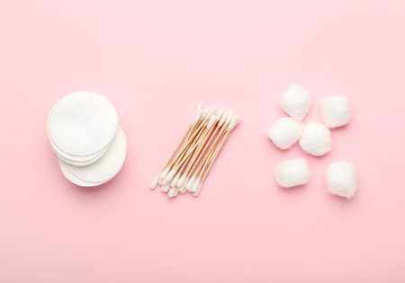 Cotton swabs, pads and balls on color backgroundの写真素材