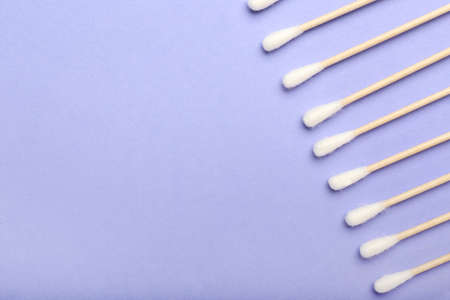 Cotton swabs on color background