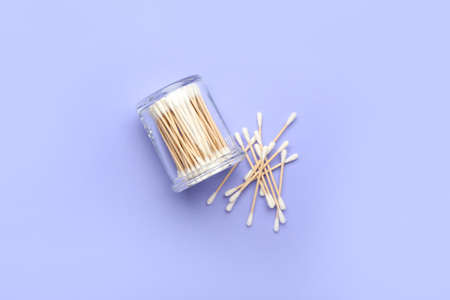 Glass with cotton swabs on color backgroundの写真素材