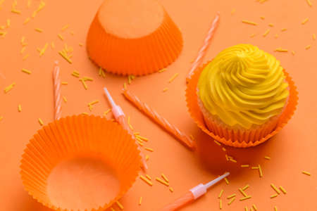Composition with tasty Birthday cupcake and candles on color background, closeupの写真素材