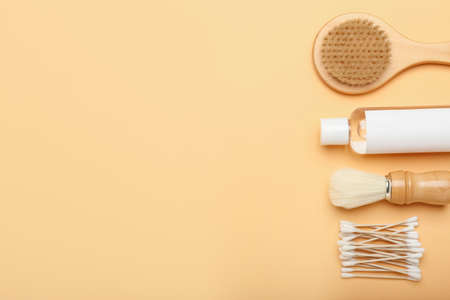 Cotton swabs, brushes and bottle of cosmetic product on color backgroundの写真素材