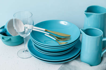 Set of clean dishes on color backgroundの写真素材
