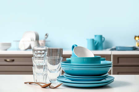 Set of clean dishes on the table in the kitchenの写真素材