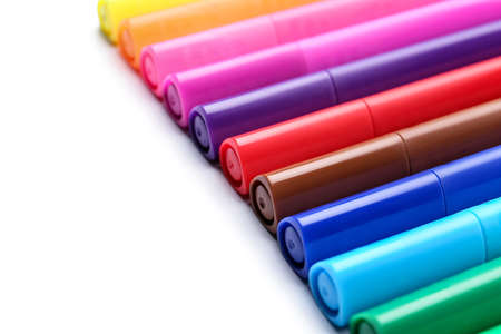 Colorful markers on white background, closeup
