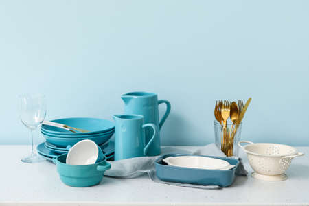 Set of clean dishes on color background