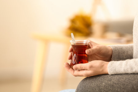 Woman drinking Turkish tea at home, closeupの写真素材
