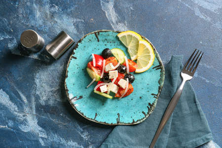 Plate of tasty Greek salad on tableの写真素材