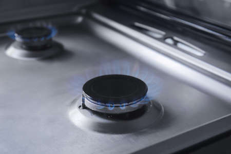 Gas burner with blue flame on domestic stove