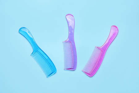 Plastic hair combs on color background