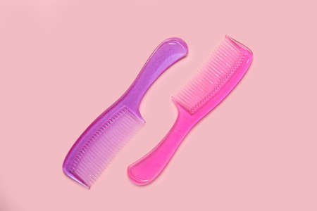 Plastic hair combs on color background