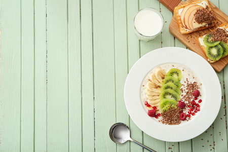 Tasty desserts with flax seeds on color wooden backgroundの写真素材