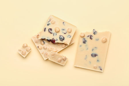 Pieces of tasty white chocolate on color backgroundの写真素材