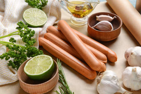 Parchment with tasty sausages, garlic and lime, closeupの写真素材