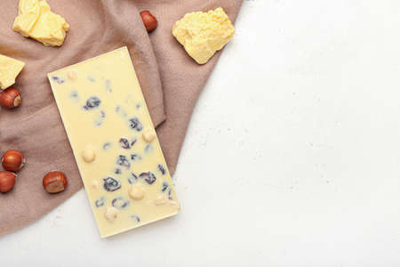 Tasty white chocolate with nuts on light backgroundの写真素材