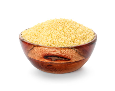 Bowl with raw couscous on white backgroundの写真素材