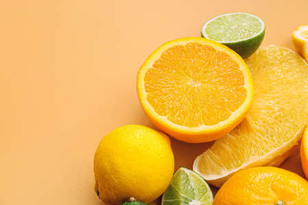 Fresh citrus fruits on color background