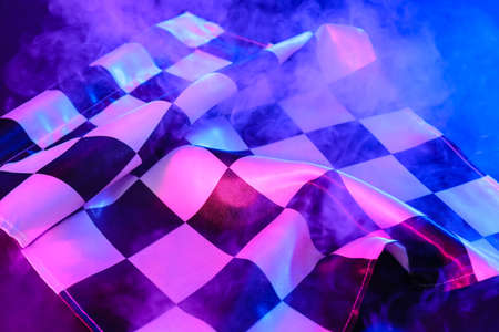 Racing flag and smoke on dark backgroundの写真素材