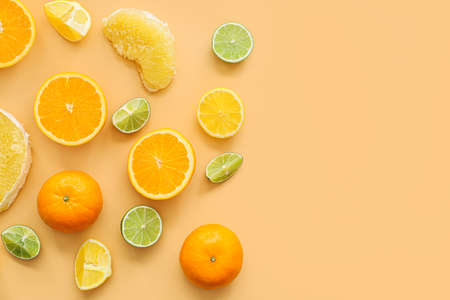 Fresh citrus fruits on color backgroundの写真素材