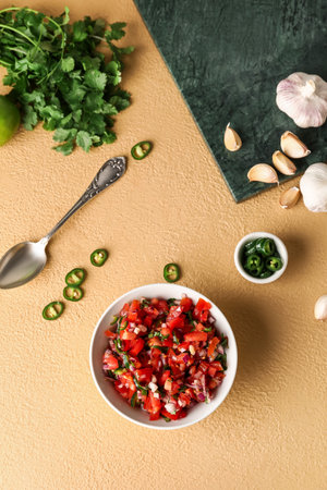 Bowl of tasty Pico de Gallo salsa on color backgroundの写真素材