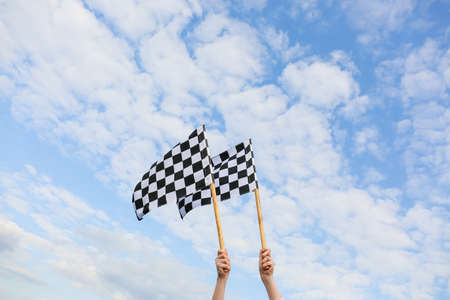 Woman with racing flags outdoorsの写真素材