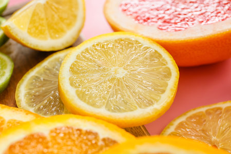 Slices of citrus fruits on color background, closeupの写真素材