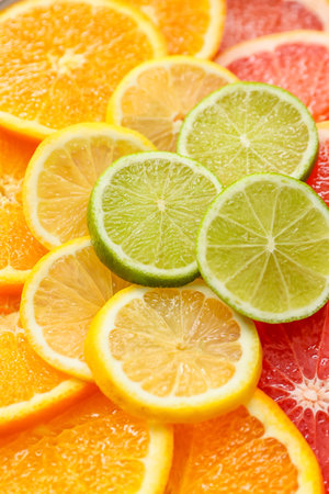 Slices of different citrus fruits as background, closeupの写真素材