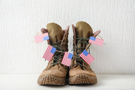 Military boots with USA flags on white backgroundの写真素材