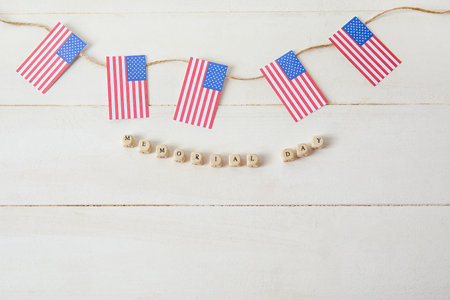 Text MEMORIAL DAY and USA flags on white wooden backgroundの写真素材