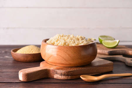 Bowl with tasty couscous on wooden backgroundの写真素材