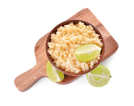 Bowl with tasty couscous and lime on white backgroundの写真素材