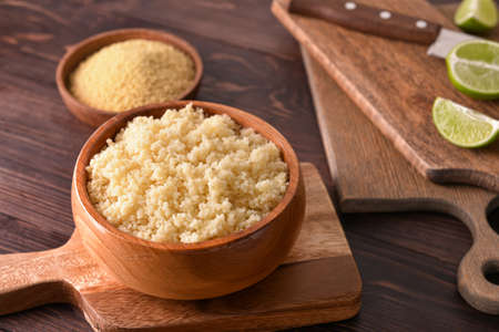 Bowl with tasty couscous on wooden backgroundの写真素材
