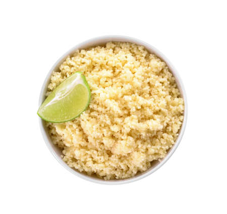 Bowl with tasty couscous and lime on white backgroundの写真素材