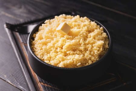 Bowl with tasty couscous on dark wooden backgroundの写真素材