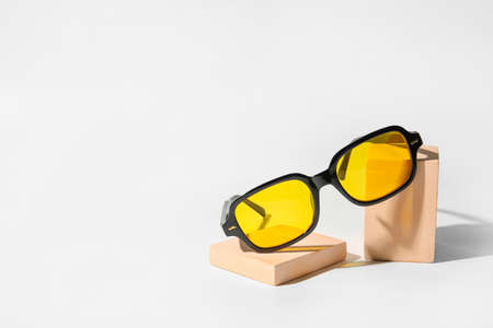 Stylish sunglasses on light background