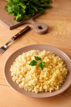 Plate with tasty couscous on wooden backgroundの写真素材