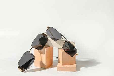 Different modern sunglasses on light backgroundの写真素材