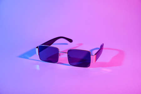 Stylish sunglasses on color backgroundの写真素材