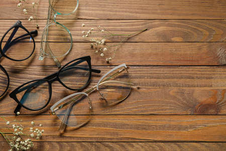 Different stylish eyeglasses on wooden backgroundの写真素材