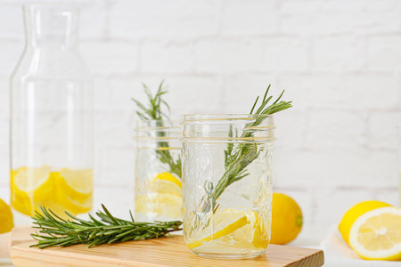 Glasses of tasty lemonade with rosemary on light backgroundの写真素材